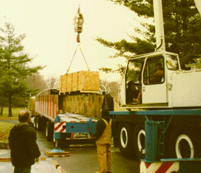 Photo of yoke section being lifted off truck with a crane.